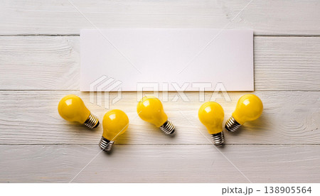 Yellow Light Bulbs with Blank Sheet , Idea, Innovation and Copy Space Concept Yellow Light Bulbs with Blank Sheet , Idea, Innovation and Copy Space Concept 138905564