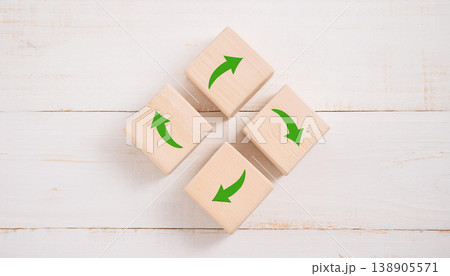 Green Arrows Forming Circular Motion on Wooden Blocks , Sustainability, Recycling, and Process Flow Concept Green Arrows Forming Circular Motion on Wooden Blocks , Sustainability, Recycling, and Process Flow Concept 138905571
