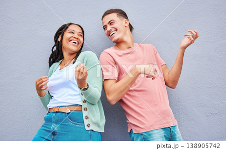 Dance, funny and interracial couple with air guitar on a wall for bonding, fun and playful in the city. Smile, laughing and black woman with a man playing an imaginary instrument for comedy together Dance, funny and interracial couple with air guitar on a wall for bonding, fun and playful in the city. Smile, laughing and black woman with a man playing an imaginary instrument for comedy together 138905742