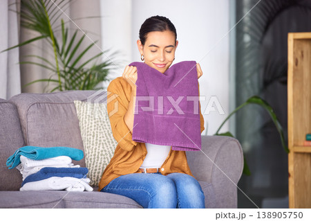 Woman, cleaning and smell towel, fresh and clean laundry in home with happy smile. Content female relax and smelling the scent of washing, happiness and fragrance of material and fabric in home Woman, cleaning and smell towel, fresh and clean laundry in home with happy smile. Content female relax and smelling the scent of washing, happiness and fragrance of material and fabric in home 138905750
