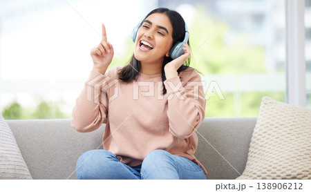 Singing and listening to music or audio with headphones musician and vocal student streaming songs at home. Young, creative and happy woman can sing song after practicing from melody and sound Singing and listening to music or audio with headphones musician and vocal student streaming songs at home. Young, creative and happy woman can sing song after practicing from melody and sound 138906212