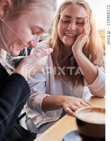 Coffee shop, funny couple of friends on social date or conversation in morning for gen z lifestyle. Young people or women laugh, talking together with latte cup in cafe or restaurant on student break 138906372