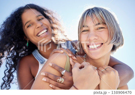 Lesbian, love and portrait of couple hug, happy and smile in sweet, romance and blue sky background. Face, lgbt and women embrace, bond and enjoy fun, relationship or freedom of togetherness outdoors 138906470