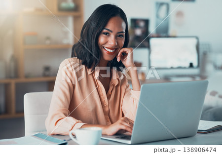 Entrepreneur, small business owner or startup employee feeling motivated by the mission and vision of her company. Portrait of a happy business woman working on her laptop at a desk in the office 138906474