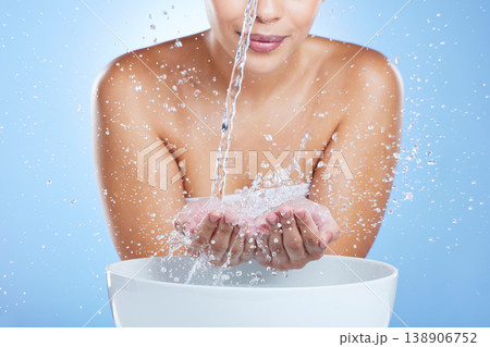 Woman, hands and water splash by basin for skincare hygiene or hydration against blue studio background. Hand of female in liquid drops washing for clean wellness or natural sustainability by sink Woman, hands and water splash by basin for skincare hygiene or hydration against blue studio background. Hand of female in liquid drops washing for clean wellness or natural sustainability by sink 138906752