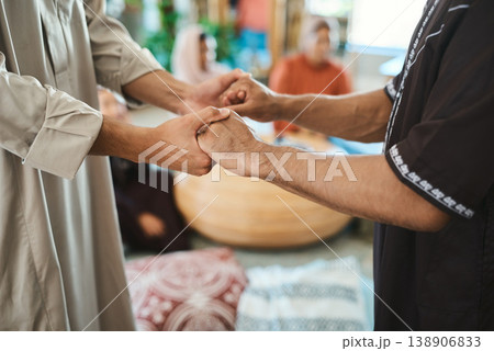 Holding hands, religion and muslim men in home, faith and respect for festive celebration or Ramadan. Islamic, social gathering and people with unity for Eid, trust and solidarity for event in house Holding hands, religion and muslim men in home, faith and respect for festive celebration or Ramadan. Islamic, social gathering and people with unity for Eid, trust and solidarity for event in house 138906833