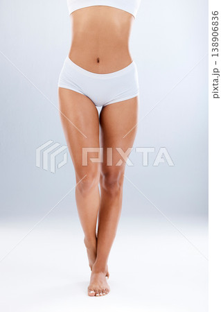 Legs, skincare and epilation with beauty and woman in underwear, skin and glow on studio background. Feet, pedicure and wellness with laser hair removal, waxing and dermatology with cosmetic care 138906836
