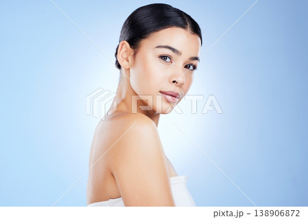 Portrait, beauty and mockup with a model black woman in studio isolated on blue background for skincare. Face, aesthetic or spa and an attractive young female posing with blank or empty mock up space 138906872