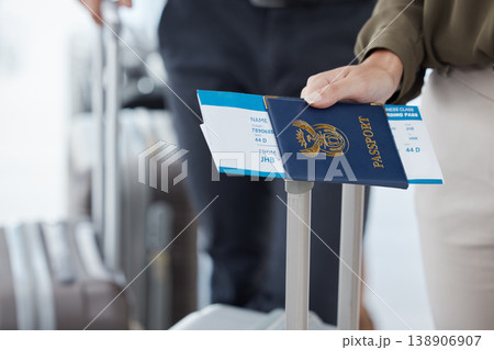 Passport, travel and airport with the hand of a passenger holding documents while waiting for a flight. Immigration, identity and boarding pass with a person holding a ticket leaving for a holiday Passport, travel and airport with the hand of a passenger holding documents while waiting for a flight. Immigration, identity and boarding pass with a person holding a ticket leaving for a holiday 138906907