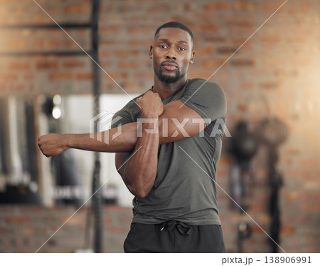 Black man, bodybuilder and stretching in gym for fitness, health or exercise with muscle, arms or focus. Man, strong or warm up for workout, training or performance for healthy body, wellness or life Black man, bodybuilder and stretching in gym for fitness, health or exercise with muscle, arms or focus. Man, strong or warm up for workout, training or performance for healthy body, wellness or life 138906991
