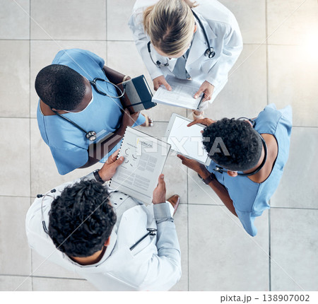 Doctor, documents and tablet in collaboration above for diagnosis and medical research at the hospital. Healthcare professionals working with technology, data and paperwork in teamwork at a clinic Doctor, documents and tablet in collaboration above for diagnosis and medical research at the hospital. Healthcare professionals working with technology, data and paperwork in teamwork at a clinic 138907002
