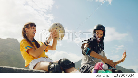 Rollerskate, skatepark and fun with a couple of friends sitting outdoor on a ramp for recreation together. Fitness, diversity or sports with a man and woman bonding outside for an active hobby 138907034