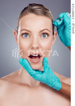 Injection, scared woman and face for skincare, collagen and beauty process in studio. Cosmetics, surprise portrait and needle for plastic surgery, facial change and aesthetic prp on background Injection, scared woman and face for skincare, collagen and beauty process in studio. Cosmetics, surprise portrait and needle for plastic surgery, facial change and aesthetic prp on background 138907114