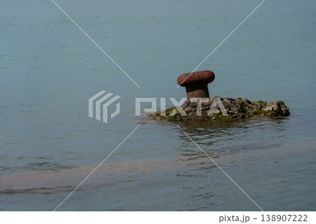 A broken, rusty bollard in the Black Sea, Batumi A broken, rusty bollard in the Black Sea, Batumi 138907222