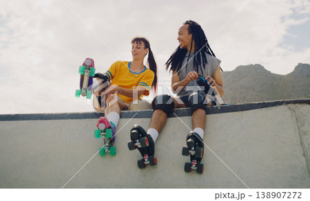 Rollerskate, skatepark and fun with a couple of friends sitting outdoor on a ramp for recreation together. Fitness, diversity or sports with a man and woman bonding outside for an active hobby 138907272
