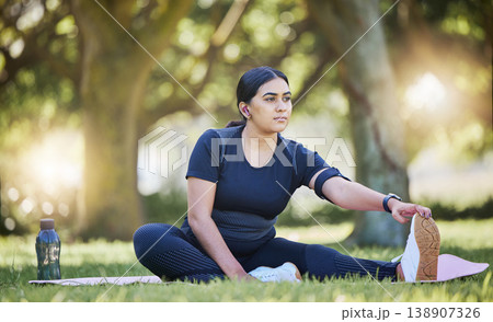 Woman, fitness stretching and nature park listening to music after a runner exercise and sports. Real plus size athlete from India stretch legs ready for wellness, health workout and running on grass Woman, fitness stretching and nature park listening to music after a runner exercise and sports. Real plus size athlete from India stretch legs ready for wellness, health workout and running on grass 138907326