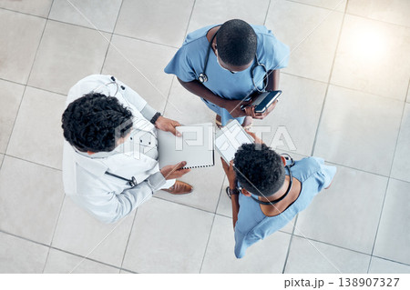 Doctors, documents and tablet for medical teamwork, insurance and wellness research in hospital. Above healthcare professional group, surgery planning and consulting digital tech data with paperwork 138907327