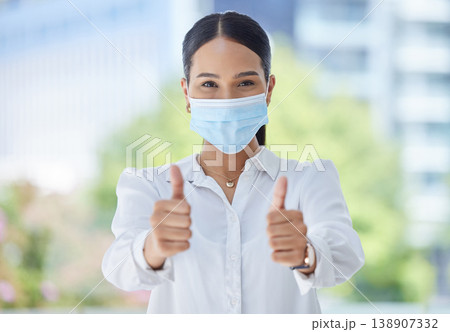 Face mask, covid compliance or thumbs up woman with hand, vision or wellness goal to stop global virus. Portrait business woman, employee or corporate worker with trust vote or vaccine support Face mask, covid compliance or thumbs up woman with hand, vision or wellness goal to stop global virus. Portrait business woman, employee or corporate worker with trust vote or vaccine support 138907332