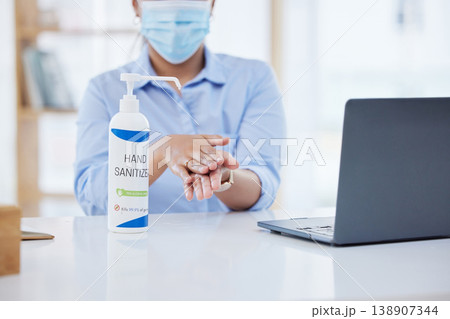 Covid, business woman at desk and hand sanitizer for hygiene and safety, protection against virus. Cleaning, laptop and health compliance of corporate, medical policy and clean working environment. Covid, business woman at desk and hand sanitizer for hygiene and safety, protection against virus. Cleaning, laptop and health compliance of corporate, medical policy and clean working environment. 138907344
