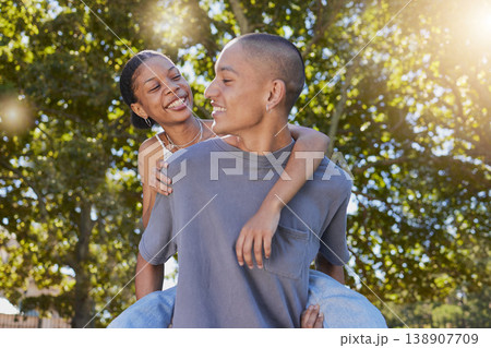 Love, tree leaf and couple hug while bonding, having fun and enjoy romantic quality time together in nature park date. Peace freedom, piggyback ride and happy black woman and gen z man play outdoor 138907709