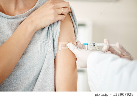 Vaccine, injection and virus cure for covid, disease and pandemic illness from doctor, healthcare or medical professional. Closeup hands, arm and needle or syringe being injected into female patient 138907929