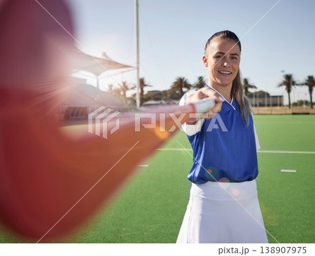 Woman hockey player, closeup and portrait on field with smile, hockey stick and happy in sunshine. Hockey, outdoor and sport girl at training, exercise and workout in sports ground, arena or stadium 138907975
