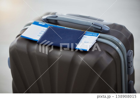 Passport, suitcase and plane ticket for travel safety in airport for immigration, holiday or vacation. Luggage, document and visa to board flight for traveling abroad overseas with a airline airplane Passport, suitcase and plane ticket for travel safety in airport for immigration, holiday or vacation. Luggage, document and visa to board flight for traveling abroad overseas with a airline airplane 138908015