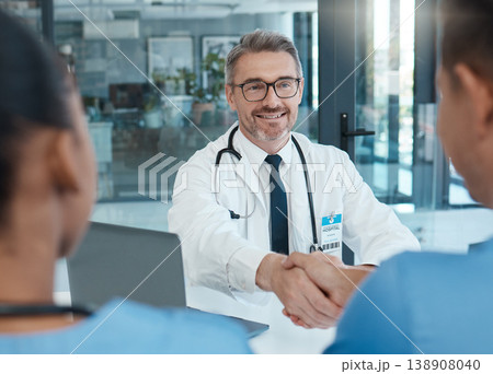 Handshake, nurse and doctor shaking hands after success in a medical surgery at a trustworthy hospital. Partnership, collaboration and physician welcomes a healthcare worker to the team in a meeting Handshake, nurse and doctor shaking hands after success in a medical surgery at a trustworthy hospital. Partnership, collaboration and physician welcomes a healthcare worker to the team in a meeting 138908040
