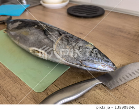Whole Raw Fish on Cutting Board with Kitchen Knife Whole Raw Fish on Cutting Board with Kitchen Knife 138909846
