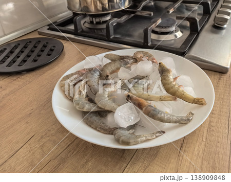 Raw Shrimp on Ice Plate in Kitchen Setting Raw Shrimp on Ice Plate in Kitchen Setting 138909848