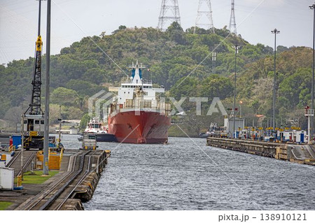 Cargo ship entering Panama Canal lock with tugboats Cargo ship entering Panama Canal lock with tugboats 138910121
