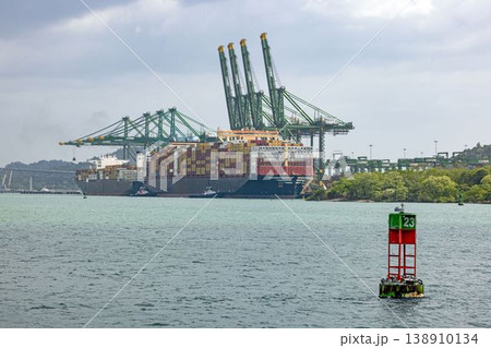 Container ship at Panama Canal port with cranes and buoy Container ship at Panama Canal port with cranes and buoy 138910134