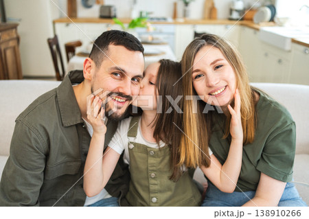 Happy family at home. Mother father children daughter relaxing on sofa indoor. Mom dad parents kid girl relax playing hugging having fun together. Family smiling laughing enjoying tender moment Happy family at home. Mother father children daughter relaxing on sofa indoor. Mom dad parents kid girl relax playing hugging having fun together. Family smiling laughing enjoying tender moment 138910266