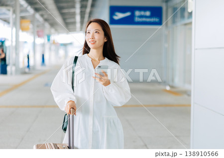空港でスマホを見る女性 「撮影協力:関西国際空港(KIX)」 空港でスマホを見る女性 「撮影協力:関西国際空港(KIX)」 138910566