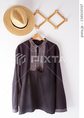 Ukrainian clothes embroidered man shirt. Blue gray and black threads background. Vyshyvanka is a symbol of Ukraine. Embroidery cross stitching. National Ukrainian stitch. Traditional clothing symbol 138910597