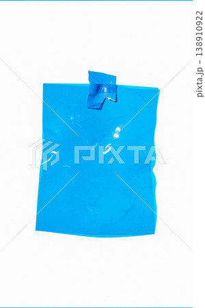 Blank blue crumpled plastic film sheet attached to a white background with tape, providing copy space Blank blue crumpled plastic film sheet attached to a white background with tape, providing copy space 138910922