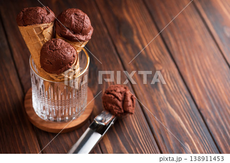 Chocolate Ice Cream Cones on Dark Wooden Background Chocolate Ice Cream Cones on Dark Wooden Background 138911453