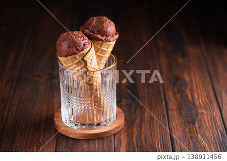Chocolate Ice Cream Cones on Dark Wooden Background Chocolate Ice Cream Cones on Dark Wooden Background 138911456