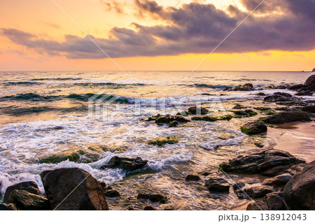 sea beach at sunrise. wonderful landscape for summer vacations in europe. dramatic view of orange sky above waves. epic seascape image with rocky coast. bulgaria travel background with water splash sea beach at sunrise. wonderful landscape for summer vacations in europe. dramatic view of orange sky above waves. epic seascape image with rocky coast. bulgaria travel background with water splash 138912043