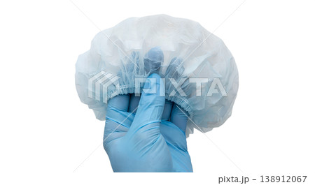 Hand holding disposable blue medical bouffant hair cap, isolated on transparent background, representing hygiene, food service, and healthcare settings Hand holding disposable blue medical bouffant hair cap, isolated on transparent background, representing hygiene, food service, and healthcare settings 138912067