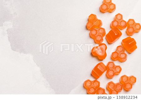 Jelly gummies fruit vitamins on bright background, food supplements.Orange vitamins candies 138912234