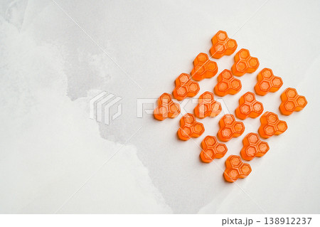 Orange vitamins jelly gummies on bright background, food supplements with copy space, top view 138912237