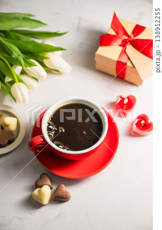 Valentine's day. Cup of coffee, heart chocolates, gift box and spring white tulip flower bouquet. Mother's day Valentine's day. Cup of coffee, heart chocolates, gift box and spring white tulip flower bouquet. Mother's day 138912255