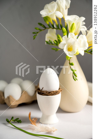 Spring, Easter background. White freesias flowers in a vase with white eggs. 138912262