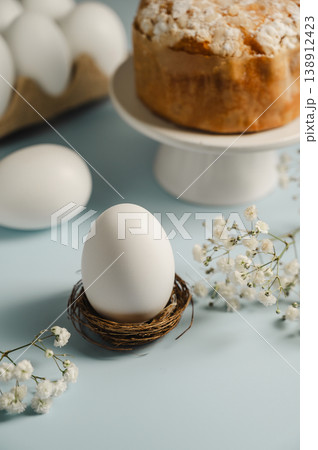 Easter white egg in the nest and easter cake with gypsophila white flower. Spring holidays background 138912423