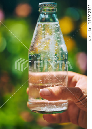 Refreshing moment captured in a sunny garden with sparkling water 138912595