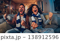 Excited sports fans celebrate victory together with joyful enthusiasm 138912596