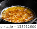 Butter melting in a cast iron skillet creates a golden, sizzling delight 138912600