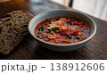 Colorful tomato and cabbage soup with hearty bread on a table 138912606