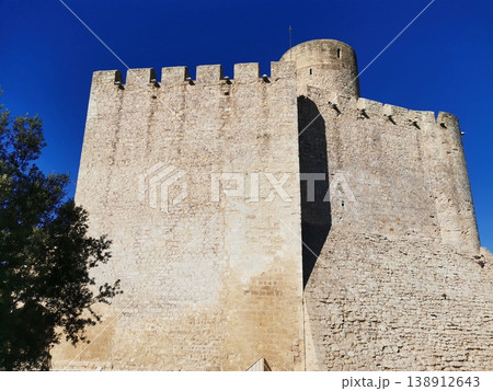 Close-up of medieval stone battlements and tower of Castellet Castle. 138912643